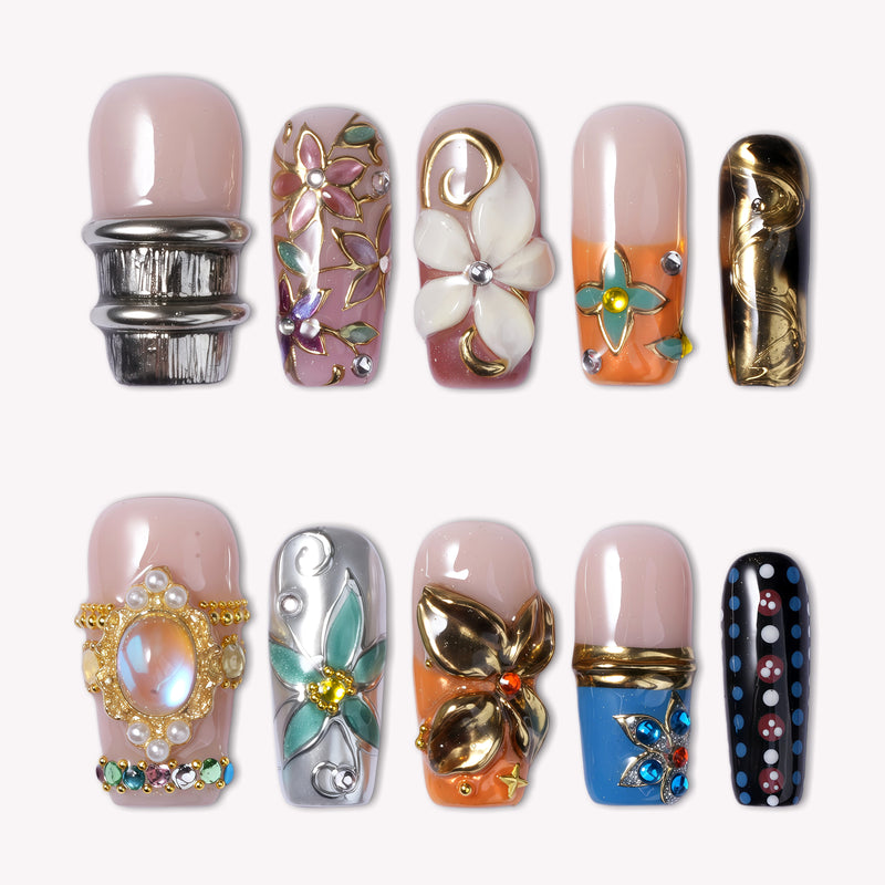 A set of 10 highly decorative luxury press-on nails with 3D floral designs, iridescent gems, pearl settings, gold butterfly and star charms, and multi-colored rhinestones on nude and pink bases, displayed in two horizontal rows against a plain white background