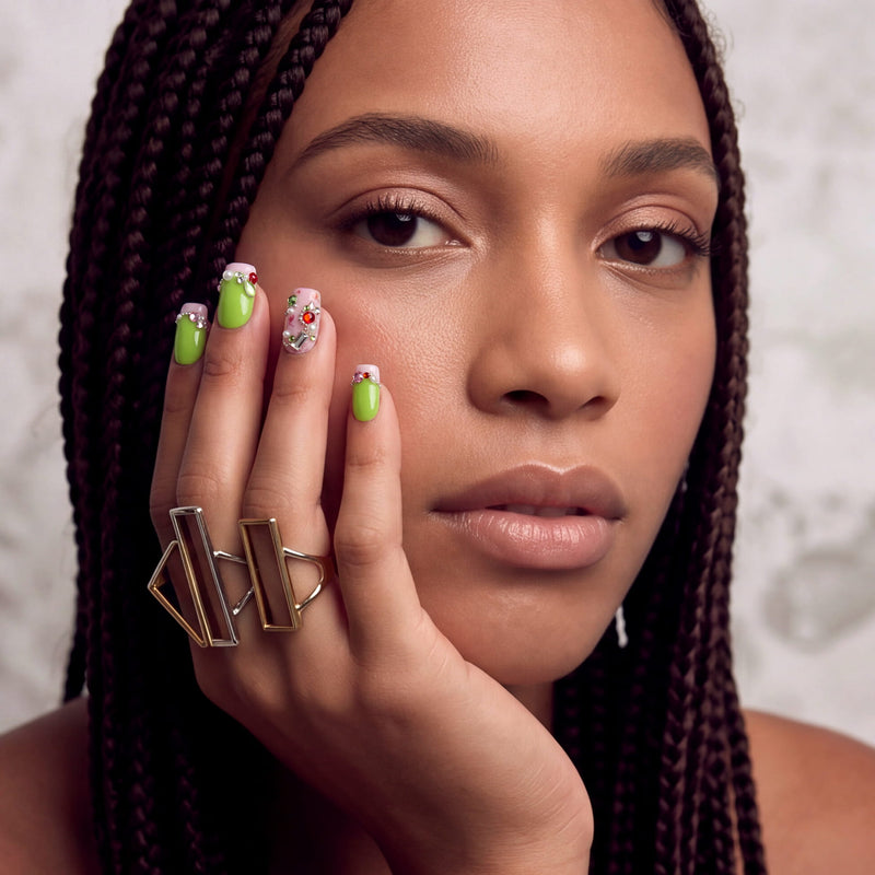 Pastel Dream handmade press-on nails worn in a close-up portrait with lime green nails and jeweled accents