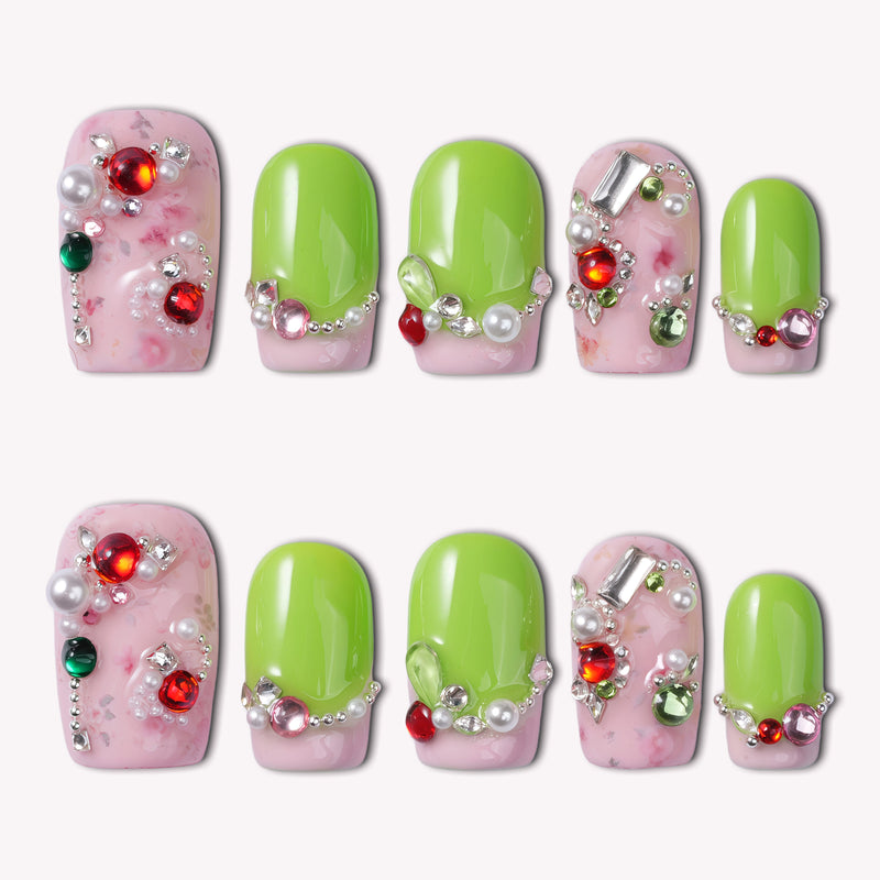 Pastel Dream handmade press-on nails in a flat lay with pink marble bases, lime green tips, and jeweled embellishments