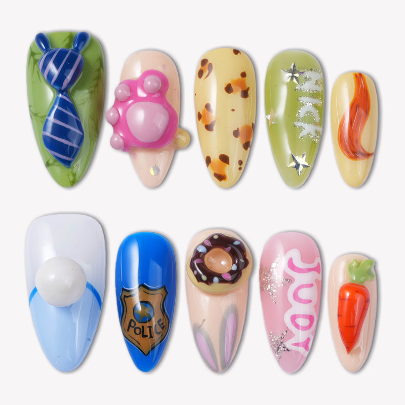 Flat lay of cartoon-themed press-on nail swatches with blue, pink, green, and orange character-inspired accents