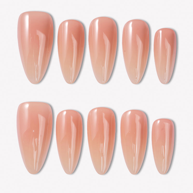 Peachy Juicy nude almond press-on nails with a glossy finish arranged in a white background flat lay