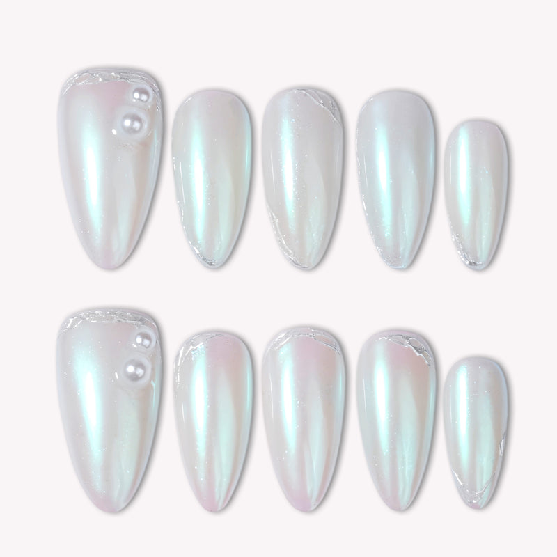 Pearl white iridescent press-on nails arranged in a flat lay