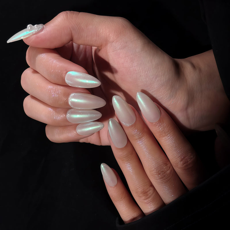 Pearl white iridescent press-on nails arranged in a set layout
