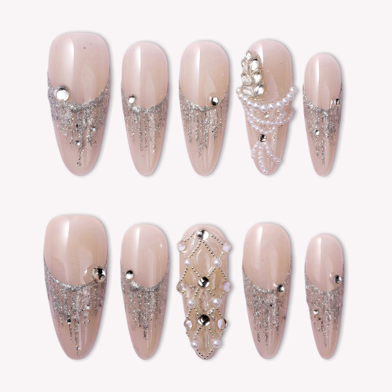 Pearl Cascade press-on nails in nude and silver with pearl and crystal accents arranged on a white background