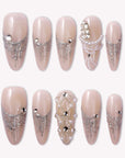 Pearl Cascade press-on nails in nude and silver with pearl and crystal accents arranged on a white background