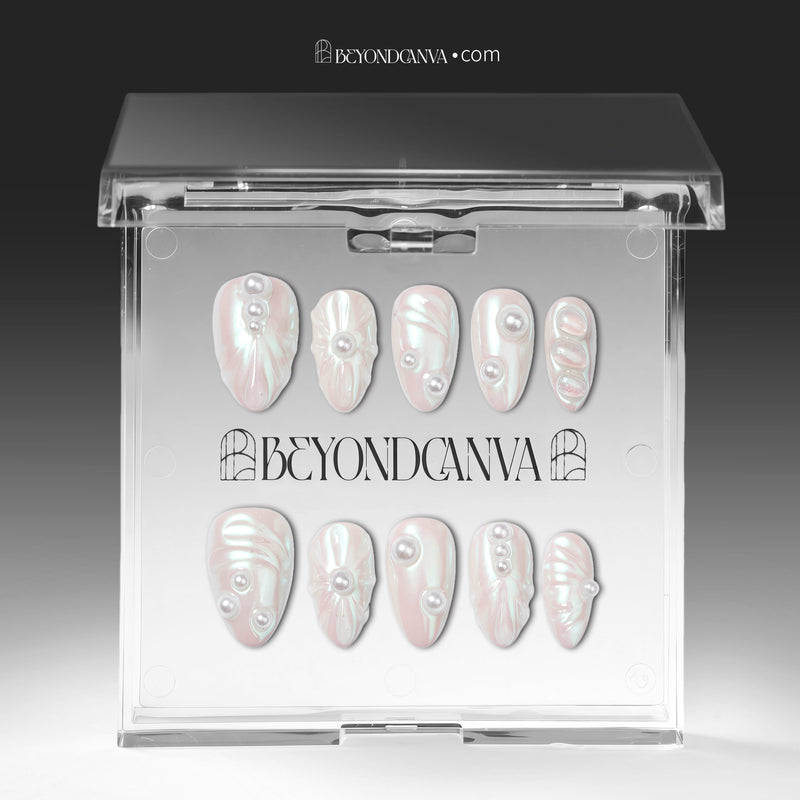 Branded acrylic packaging display showing pale blush pearlescent nails arranged in two rows.