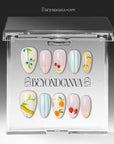 Set of handmade press-on nails with fruit motifs, blue stripes, and pastel accents arranged on a white background.