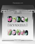 Pink Caladium press-on nails displayed in a clear Beyondcanva packaging case with floral leaf designs inside