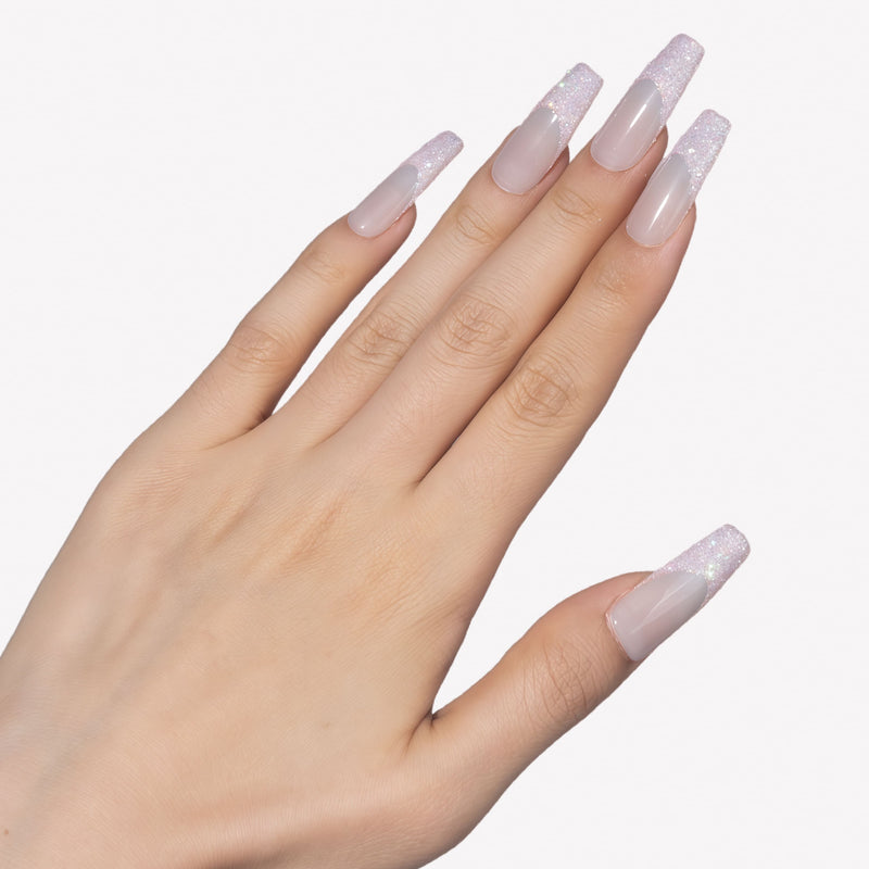 Side hand model wearing Pink Confetti press-on nails with sheer nude pink square bases and sparkling pink silver glitter French tips