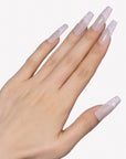 Side hand model wearing Pink Confetti press-on nails with sheer nude pink square bases and sparkling pink silver glitter French tips