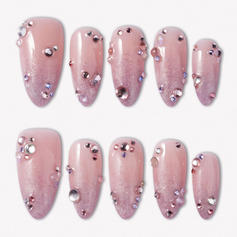 Pink Fairy Dust press-on nails with soft pink shimmer, cat-eye sparkle, and scattered pink purple silver rhinestones