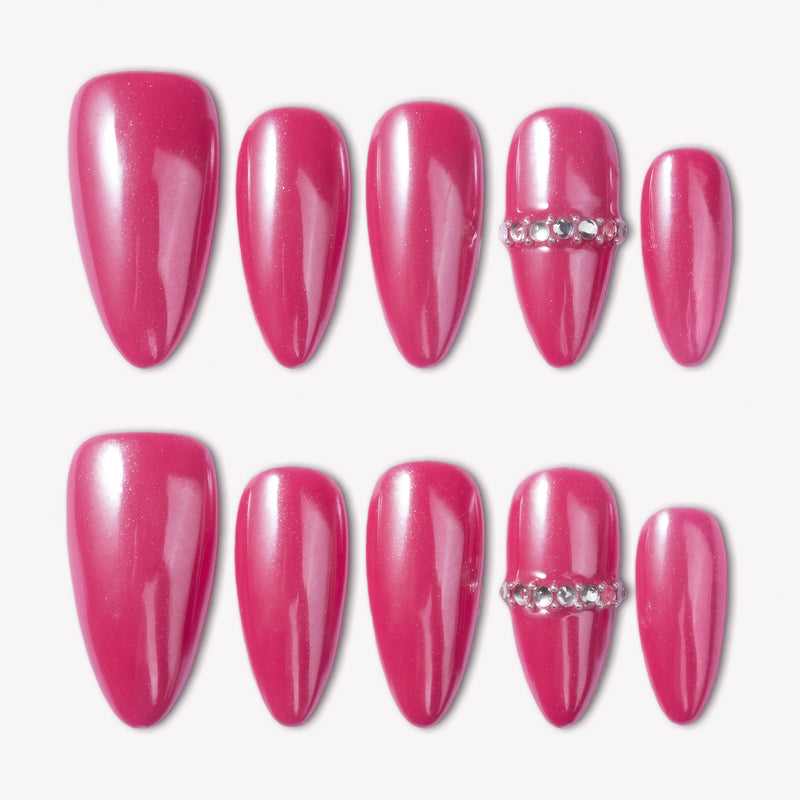 Flat lay of glossy hot pink press-on nails with a crystal accent on a white background.