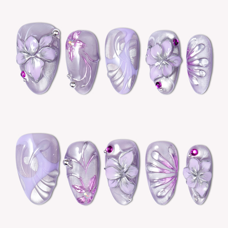 Purple Dream lavender press-on nails with raised silver flowers, magenta rhinestones and pearly shimmer