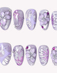 Purple Dream lavender press-on nails with raised silver flowers, magenta rhinestones and pearly shimmer