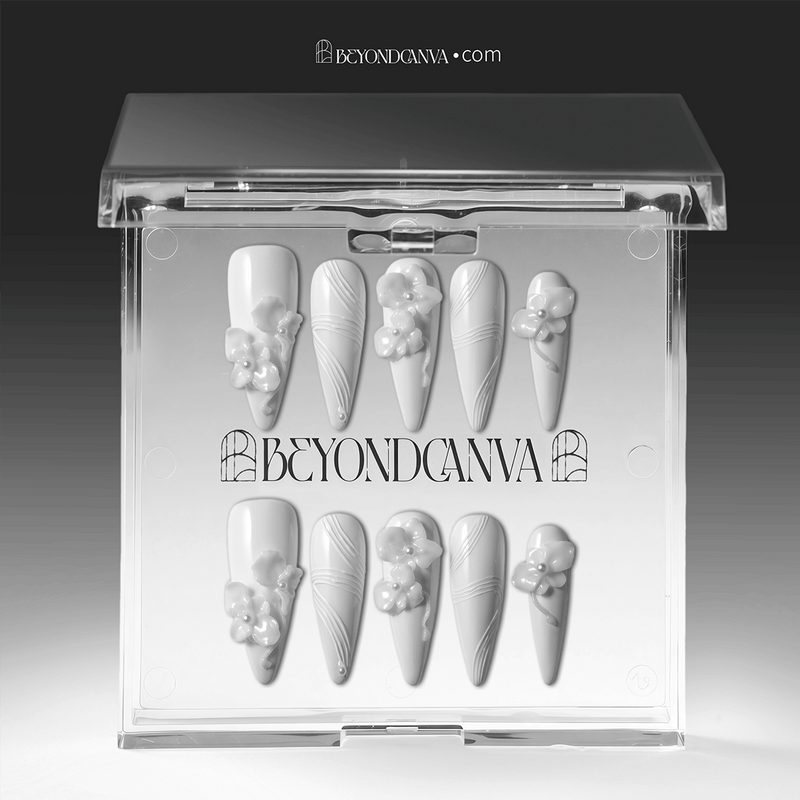 Packaging display of Quiet Sculpture press-on nails in a clear BeyondCanva case with glossy white stiletto shapes, raised 3D flowers, pearl accents, and sculpted line textures