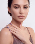 Rebel Cherry handmade press-on nails in a half portrait with blue and red accents on a hand posed at the shoulder