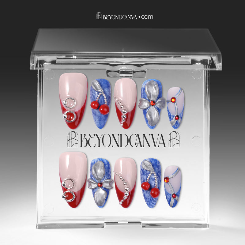 Rebel Cherry handmade press-on nails displayed in a clear case with red, blue, and silver nail designs