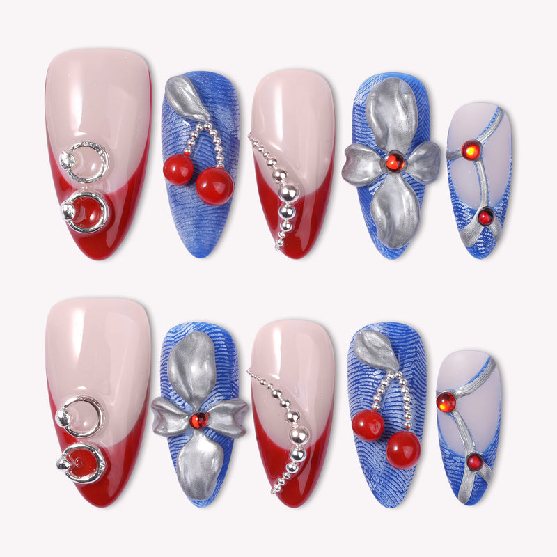 Rebel Cherry handmade press-on nails with red French tips, blue textured accents, silver bows, and cherry charms
