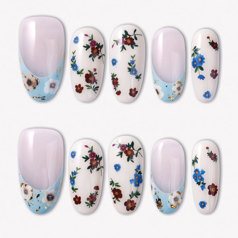 Retro Pastoral press-on nails with pale pink bases, light blue curved tips, gold foil accents, and tiny red and blue floral designs