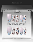 Packaging display of Retro Pastoral press-on nails in a clear BeyondCanva case with pale pink bases, light blue curved tips, gold foil accents, and tiny floral designs