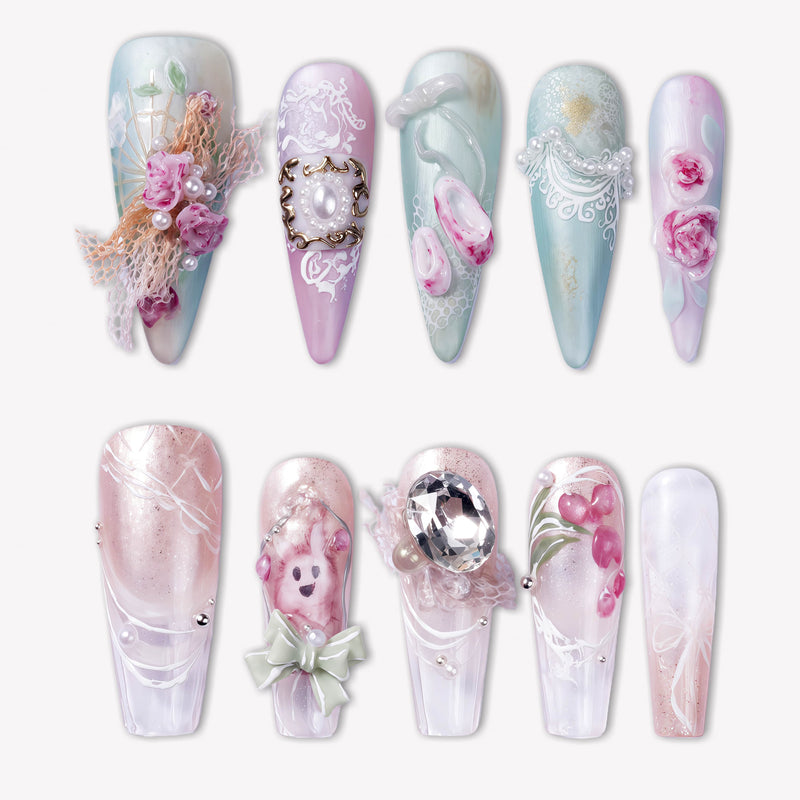 Rococo Reverie press-on nails with pastel blue and pink bases, 3D roses, pearls, lace details, bows, and rhinestone accents