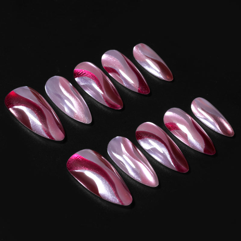 Rose Drift burgundy and pink cat eye almond press-on nail set arranged on a dark background with glossy wave details
