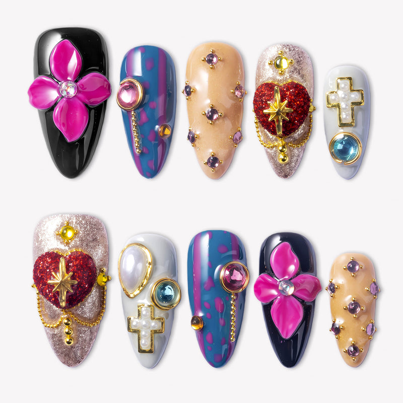 Saint of Desire press-on nails with pink flowers, red heart charms, gold cross accents, pearls, and colorful gemstones