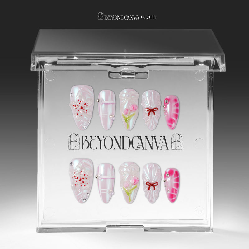Sakura Whisper pink and pearly white floral press-on nails arranged inside a clear Beyondcanva display case