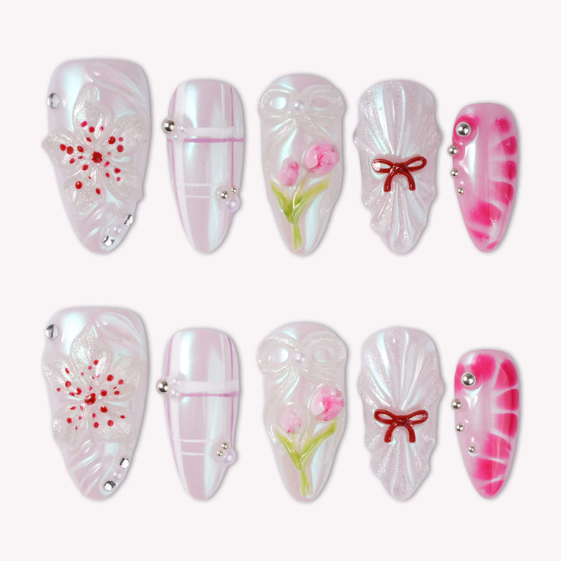Sakura Whisper pearly pink and white press-on nails with cherry blossoms, tulips, plaid lines, bows and silver studs