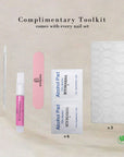 Complimentary toolkit with nail file, cuticle pusher, alcohol pads, and adhesive tabs for press-on nails.