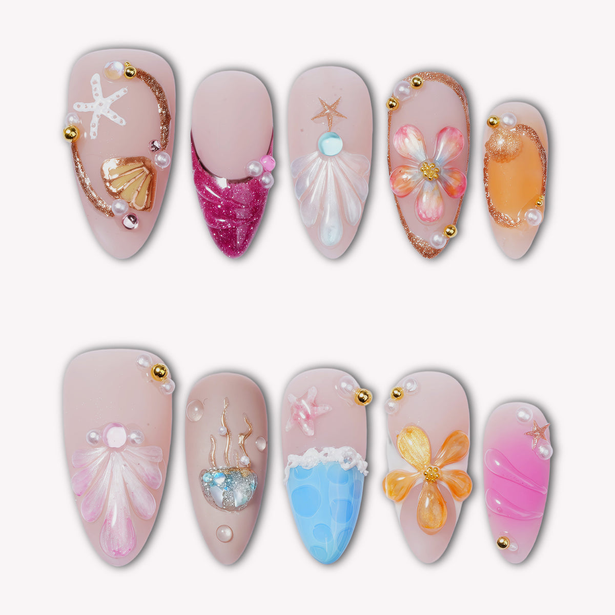 Colorful press-on nails with seashell, starfish, flower, coral, and ocean-inspired details arranged on a white background.
