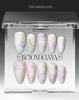 Secret Garden press-on nails displayed in a clear packaging box with floral patterns