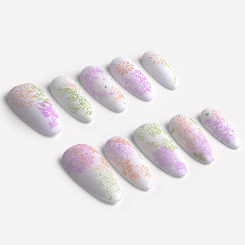 Secret Garden press-on nails arranged in a diagonal flat lay on a white background