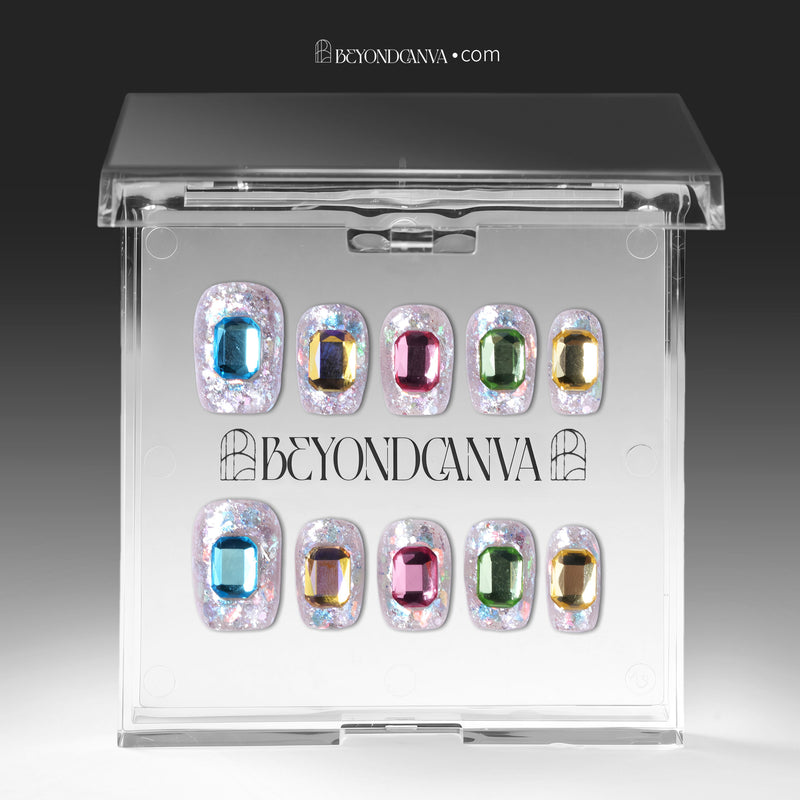 Silver holographic glitter press-on nails with multicolor emerald-cut rhinestones displayed in BeyondCanva packaging.