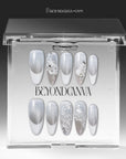 Snowlace Whisper press-on nails displayed in a clear BeyondCanva case with silver shimmer, white lace accents, and crystal embellishments
