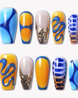 Solar Tide press-on nails with bright blue, orange, and gold wave designs, marbled metallic accents, and glossy finish