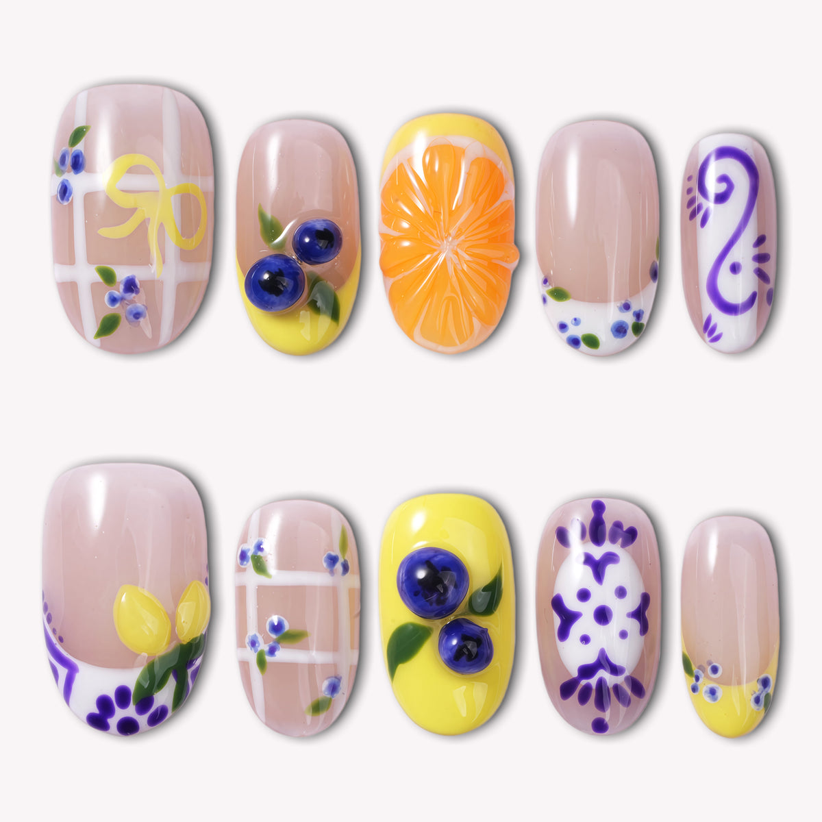 South Holiday press on nails with colorful floral and fruit-inspired details arranged in a flat lay on a white background