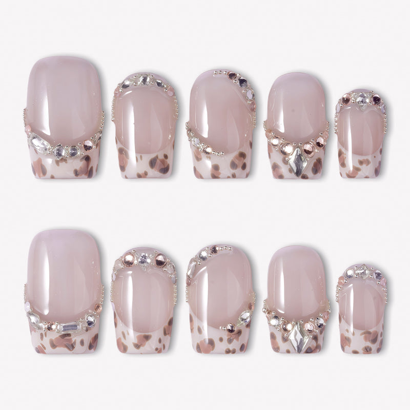 Sugar Kitten press-on nails with nude pink square bases, leopard print French tips, and clear rhinestone accents