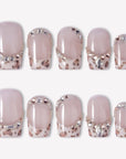 Sugar Kitten press-on nails with nude pink square bases, leopard print French tips, and clear rhinestone accents