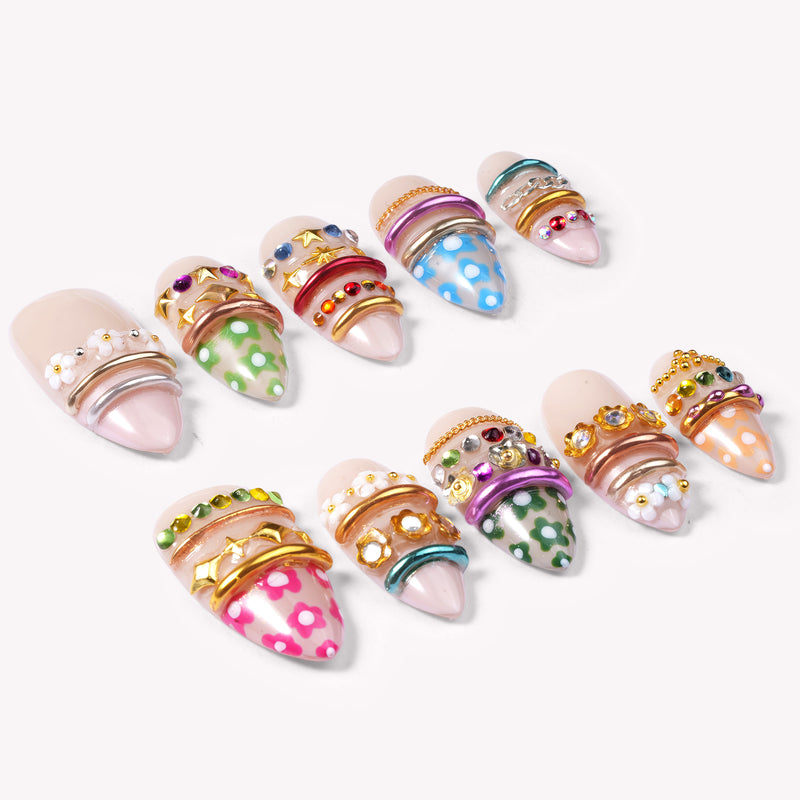 Sunset Gypsy handmade press-on nails arranged as a set on a white background with nude, green, blue, and pink accents