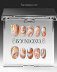 Clear BeyondCanva box displaying brown and white shell-pattern press-on nails.