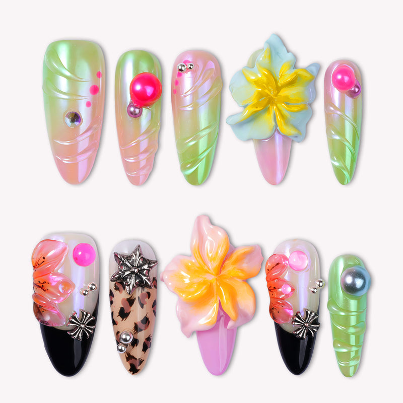 Flat lay of Tropical Cyber-Shell handmade press-on nails with neon green, pink, yellow, and black floral accents.