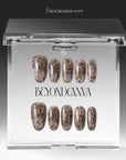 Packaging display of beige and brown snakeprint press-on nails in a clear box