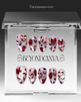 Angled hand model shot wearing red and white marble press-on nails