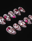 Portrait of a hand model wearing red and white marble press-on nails
