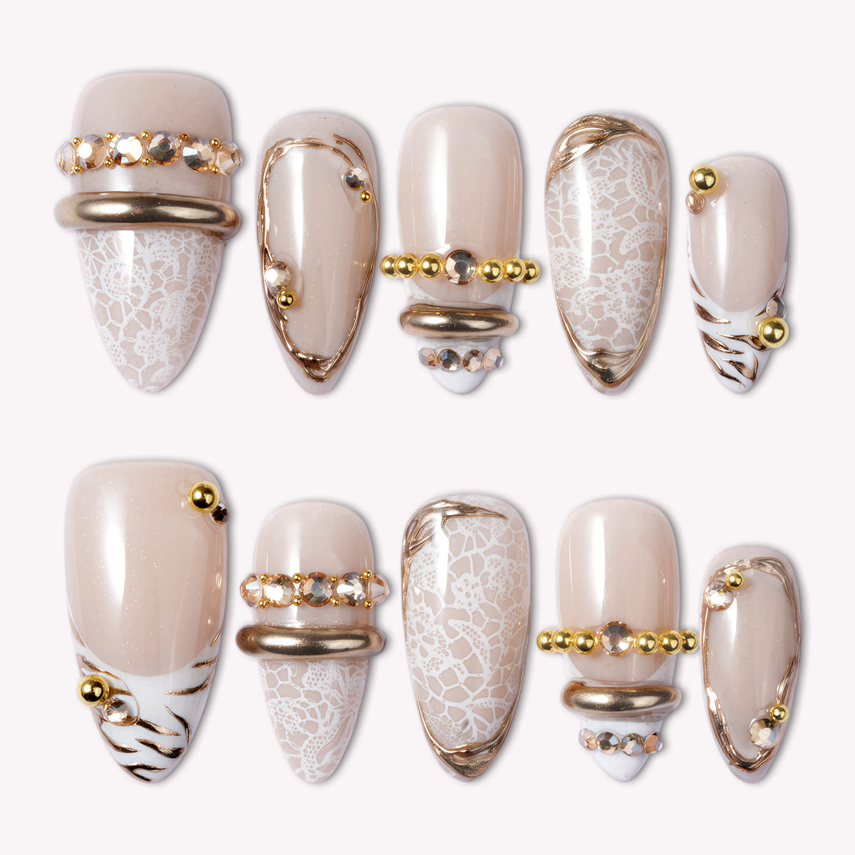 Wild Romance Fantasy handmade press-on nails with nude bases, white lace texture, gold beads, and metallic accents