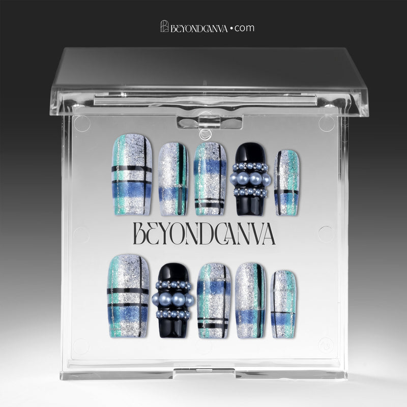 Winter Gridlight press-on nails displayed in a clear BeyondCanva case with silver glitter, aqua blue, black, and pearl accents
