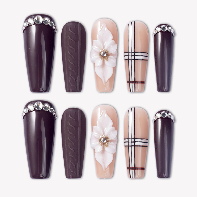 Winter Serenade press-on nails with deep purple tips, nude plaid accents, white 3D flowers, and rhinestone details